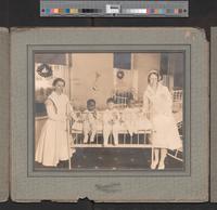 [Group portrait of two nurses with two African American and an Asian baby at an unidentified hospital] [graphic] / The Hennigar Studio, 4908 Frankford Ave.