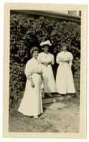 [Three women in an entryway covered with ivy] [graphic].