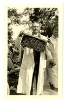 E.C. Britton with bees [graphic].