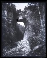 Natural Bridge, [VA], from seat on path leading down under it. G[rand] A[rmy of the] R[epublic] sign on hill [graphic].