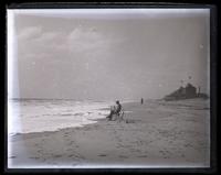 Beach. T[heodore] W[illiam] Richards sitting on wreckage. [Sea Girt, NJ] [graphic].