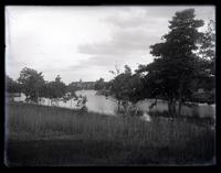 [River, trees lining banks, edifices in background, possibly Sea Girt, NJ] [graphic].