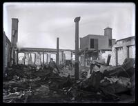 [Man among fire ruins of a building] [graphic].