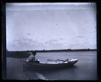 [Man on boat Thalatta docked on river bank] [graphic].