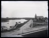 [Inlet from previous view, several canoes near covered pier, large Victorian edifice near roads near shore, Spring Lake, NJ] [graphic].