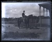 Bessie on Dan [horse] in front of cottage, [Avocado, Sea Girt, NJ] [graphic].