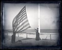 Alice [Shipley] & Bessie hauling down flag, [Sea Girt, NJ] [graphic].