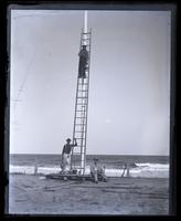 Shem Pearce & his brother painting the flag pole, Theo[dore William] Richards sitting at base of pole, [Sea Girt, NJ] [graphic].