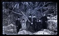 [Our party to St. Georges under Screw Pine Tree at Joyce's Dock Caves]. Sam[ue]l Brown, Mother, Mrs. J.W. Paul, May Sharp, Rachel Brown, Bessie, Father, [Bermuda] [graphic].