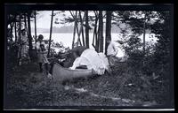 [Marriott Canby Morris Jr., Janet Morris, and Elliston Perot Morris Jr. working on a canoe], Carnival, Pocono Lake, [PA] [graphic].