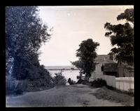 Glimpse of river and ocean from road up to lighthouse, [Sandy Hook, NJ] [graphic].