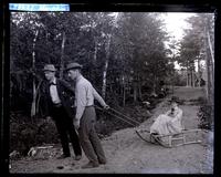 Charlie Huston & Morris Leeds pulling Bessie Carter on a wood sled, [end of Eagle Lake, Mount Desert Island, ME] [graphic].