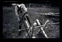 [Boy sawing wood], Pocono Lake, [PA] [graphic].