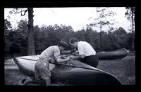 [Two men work on canoes], Down Rancocas, [NJ] [graphic].