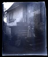 [Woman and children outside a cottage, probably England] [graphic].