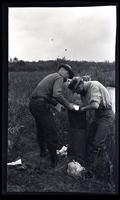 [Two men working in a field], canoeing, Egg Harbor River, NJ [graphic].