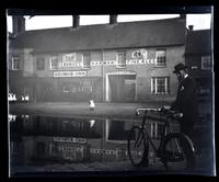 [Man with a bicycle in front of George Inn, England] [graphic].