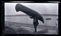 [Man carrying a canoe], Sea Girt, NJ [graphic].
