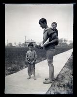 [Man carrying child on his back], Boys Parlors Camp, Wildwood, NJ [graphic].