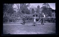 Gus mowing grass. Janet near, [131 W. Walnut Lane] [graphic].