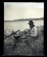 [Man cooking over a camp fire, Egg Harbor River, New Jersey] [graphic].