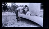 Mending canoe near Malaga, Nelson & Anne West & Carrie Shipley [graphic].