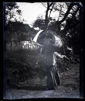 [Woman carrying large bundle, probably England] [graphic].