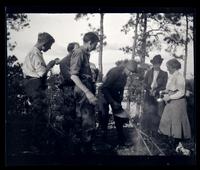 [Group around a campfire], canoeing, Egg Harbor River, NJ [graphic].