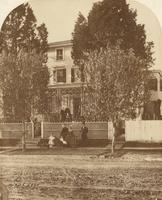 [Family posed in front of clapboard house] [graphic]