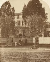 [Family posed in front of clapboard house] [graphic]