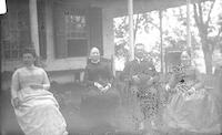 [Group in rocking chairs on Stouton lawn, Philadelphia, Pa.] [graphic].