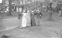 [Group standing near tennis net on Stouton lawn, Philadelphia, Pa.] [graphic].