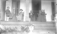 [Jane L. Webster, with group, on the porch of a residence, Lownes Clovercrest Farm, Springfield township, Pa.] [graphic].