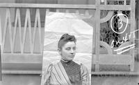 [Jane Lownes Webster posing near porch, George Bolton Lownes homestead, Baltimore Pike and Woodland Avenue, Springfield, Pa.] [graphic].