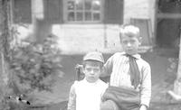 [Mabel C. and Horace D. Webster sitting in a chair posing in front of Stouton, Philadelphia, Pa.] [graphic].