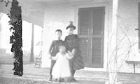 [Mabel C. and Horace D. Webster, with toddler, posing in front of Stouton, Philadelphia, Pa.] [graphic].