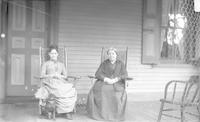 [Two women sitting on the porch of an unidentified residence] [graphic].