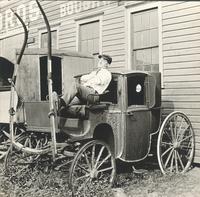 [Unidentified man sitting on old coach] [graphic].