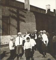 [Young men in front of shadowed brick wall, unidentified location] [graphic].