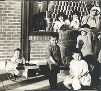 [Group of unidentified children outside of storefront] [graphic].