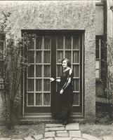 [Unidentified woman standing in front of French doors] [graphic].