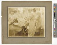 [View of operating room with Dr. J.H. Mudgett and African American men physicians and African American women nurses at a surgical procedure at Dr. J. H. Mudgett’s Private Hospital and Training School for Nurses, 2030 N. 13th Street, Philadelphia] [graphic