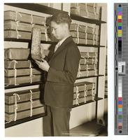 [B.L. Dai looking at books of the Nashi who inhabit the high mountains between China & Tibet several hundred years ago. Now in The Library of Congress] [graphic].