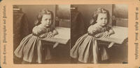 [Young girl leaning on book and chair]