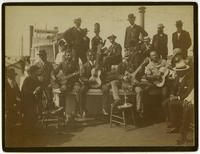 [African American minstrel group performing on a riverboat]