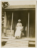 [Unidentified older African American woman on shanty porch]