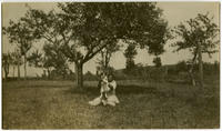 [African American woman holding a dog.]