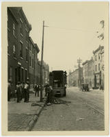 [African American construction crew installing a utility pole]