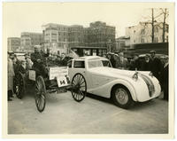 [Mr. Eckels, winner of Antique Derby at the 1934 Philadelphia Auto Show, with his automobiles, a 1892 Blackie Car and a "1934 Delage"]