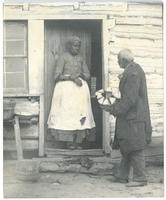 [African American man delivering firewood to an African American woman]